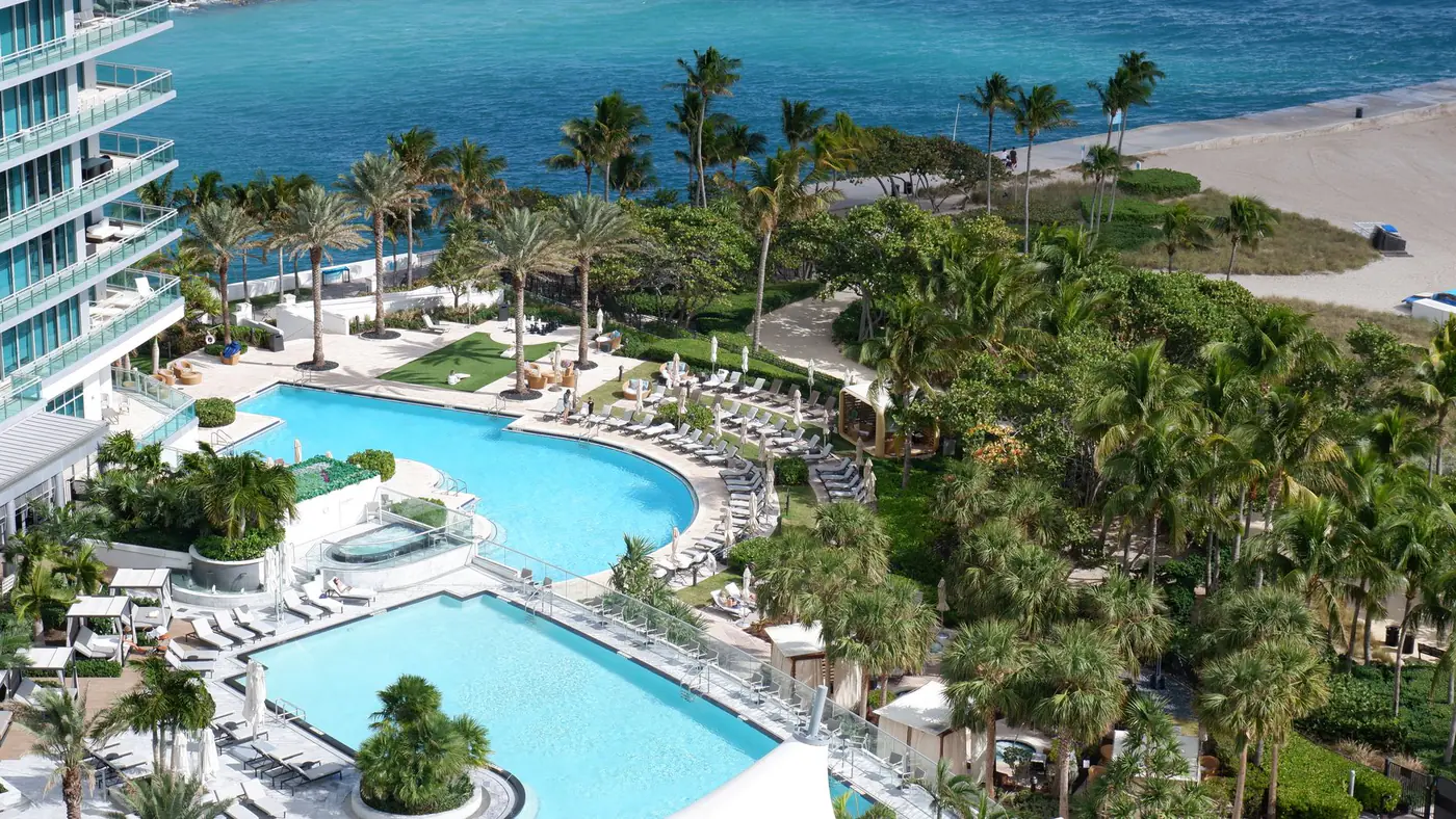 Lush Miami resort with pools and beachfront, offering a relaxing tropical escape.