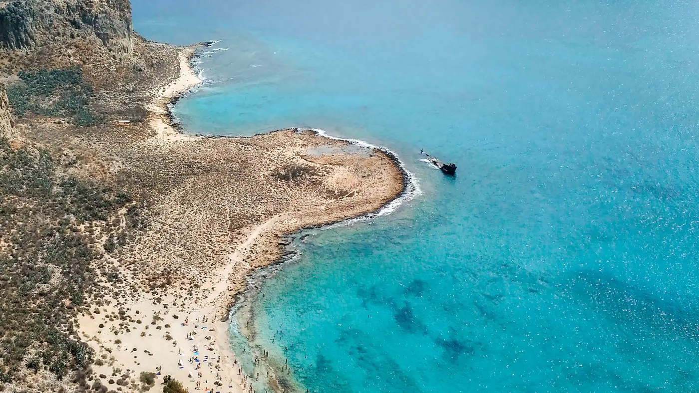 Explore the azure waters and rugged coastline of Balos Beach, Crete from above.