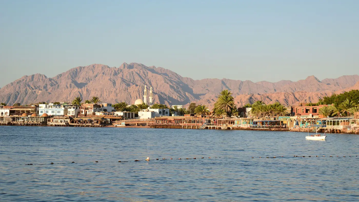 Stunning view of Dahab townscape against Sinai mountains, Egypt's coastal charm.