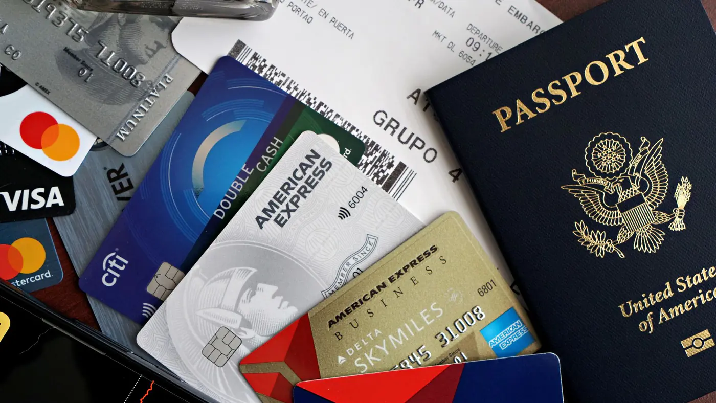 A collection of travel essentials including a passport, credit cards, and a boarding pass. Ideal for travel and finance concepts.