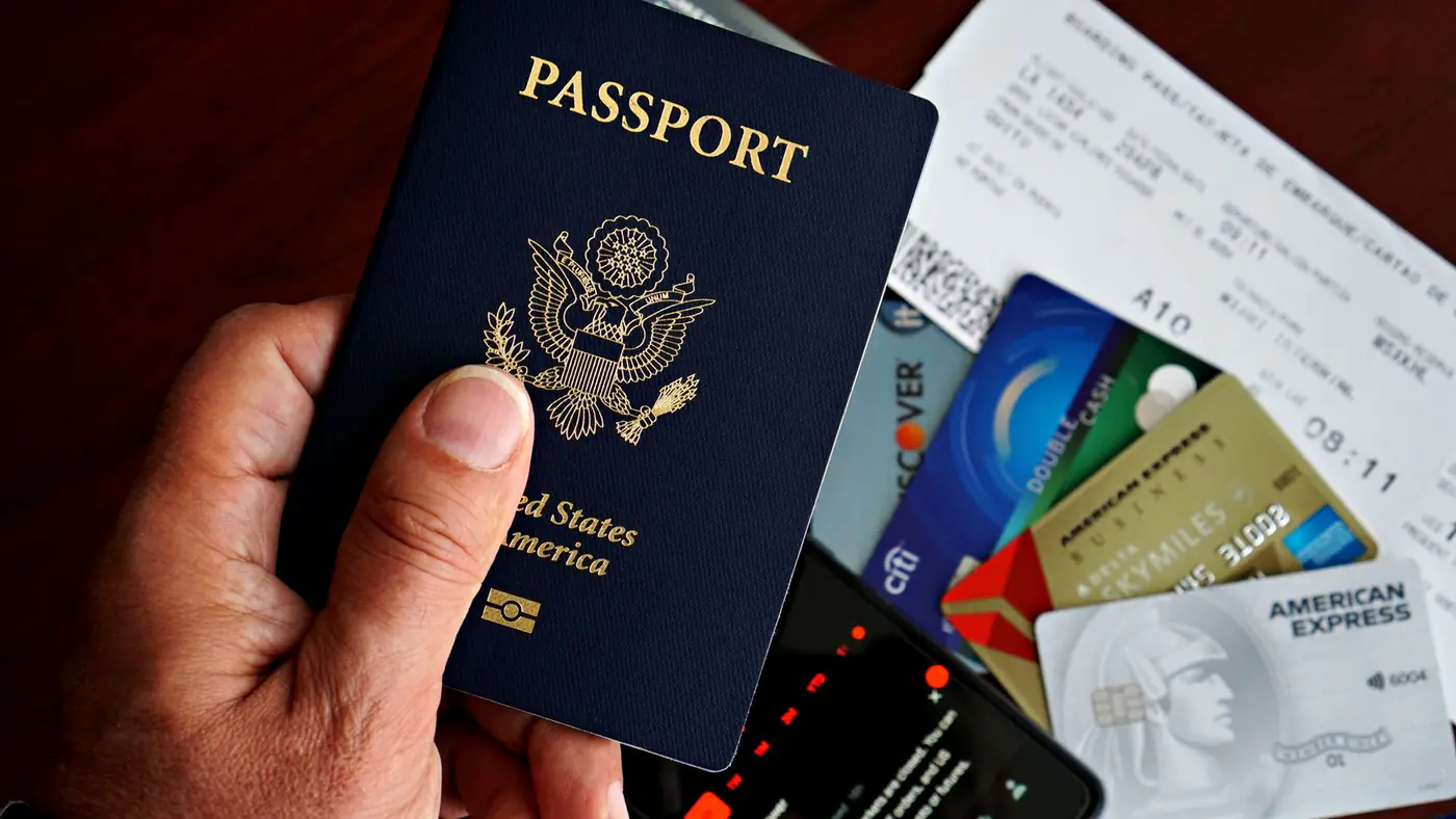 US passport with credit cards and travel documents on a table, travel preparation concept.