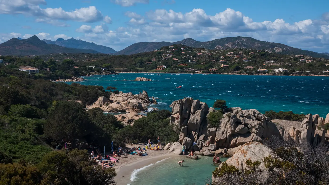 Explore the picturesque rocky coast and azure waters of Sardinia, Italy, perfect for summer travel.