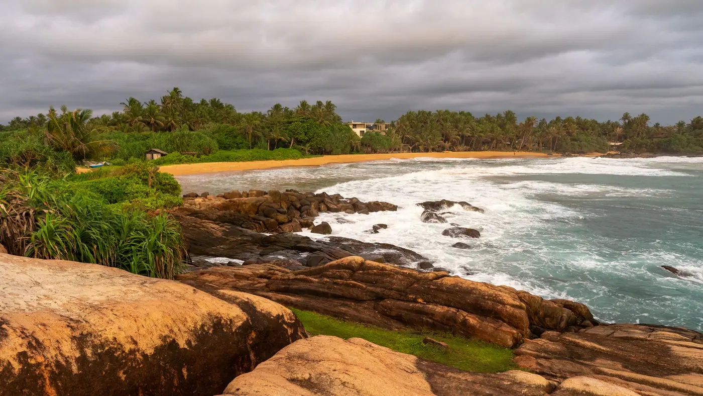 Beautiful beach and rocky shoreline view captured at sunset in Sri Lanka
