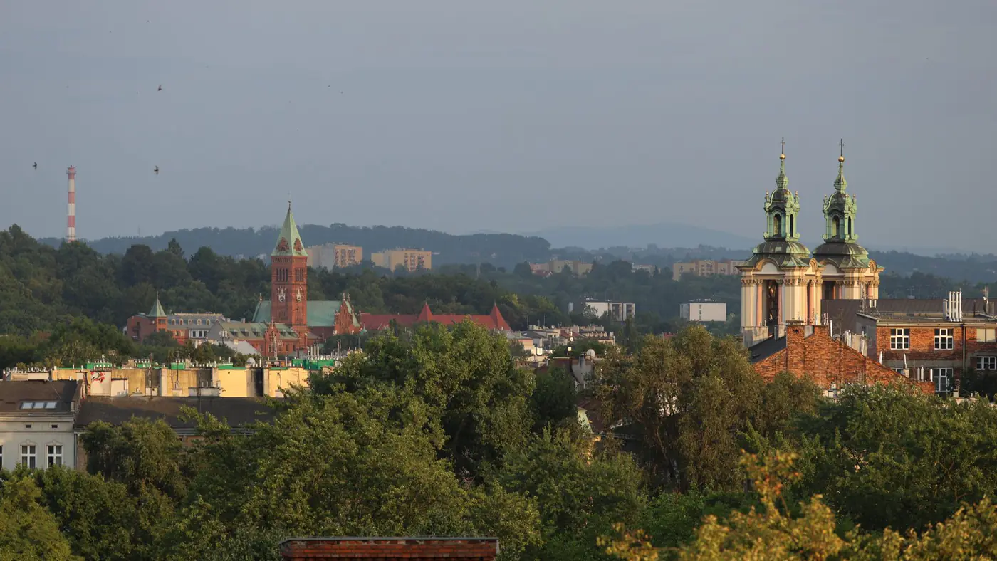 Scenic view of Krakow skyline showcasing historic church towers under a clear sky.