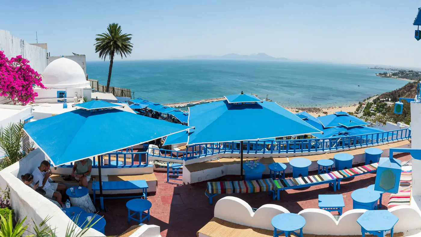 Discover a colorful seaside terrace in Carthage, Tunisia, offering stunning Mediterranean views for a perfect vacation retreat.
